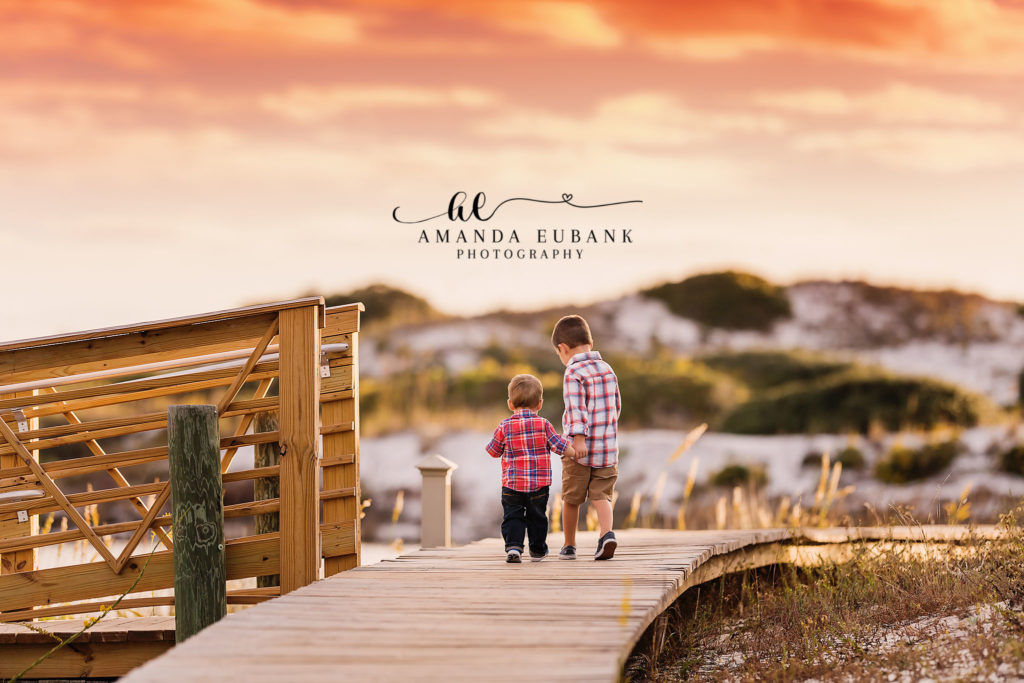 30A family portrait — candid brothers-walking-together boardwalk portrait; photographed by Amanda Eubank Photography along Florida’s Emerald Coast.