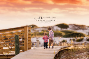 30A family portrait — candid brothers-walking-together boardwalk portrait; photographed by Amanda Eubank Photography along Florida’s Emerald Coast.