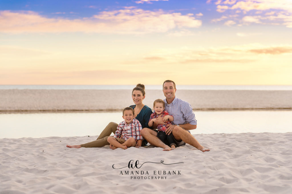 30A family portrait — walking family-of-four coastal-forest boardwalk portrait; photographed by Amanda Eubank Photography along Florida’s Emerald Coast.