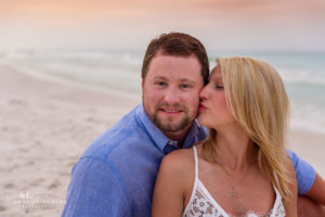 Mary and Reed strolling barefoot along the 30A shoreline at sunrise.