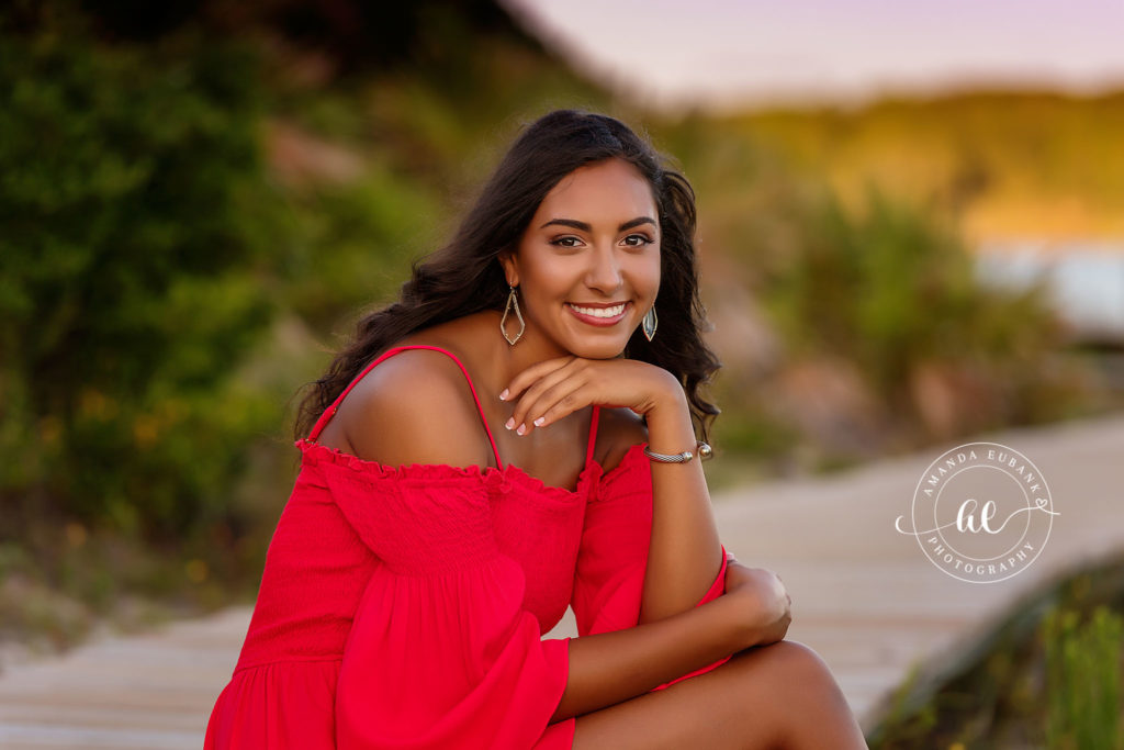 Watersound Beach photographer senior portraits of brunette in red dress with pro makeup in Seacrest Beach Florida