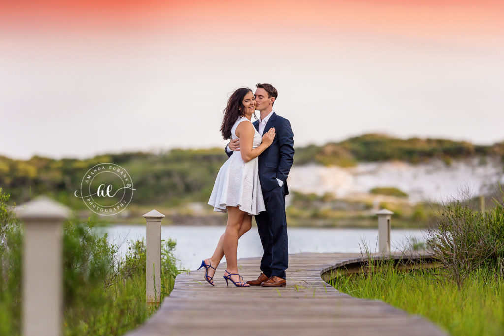 Samantha and Gordon walking away down the boardwalk path beneath a lavender twilight sky.