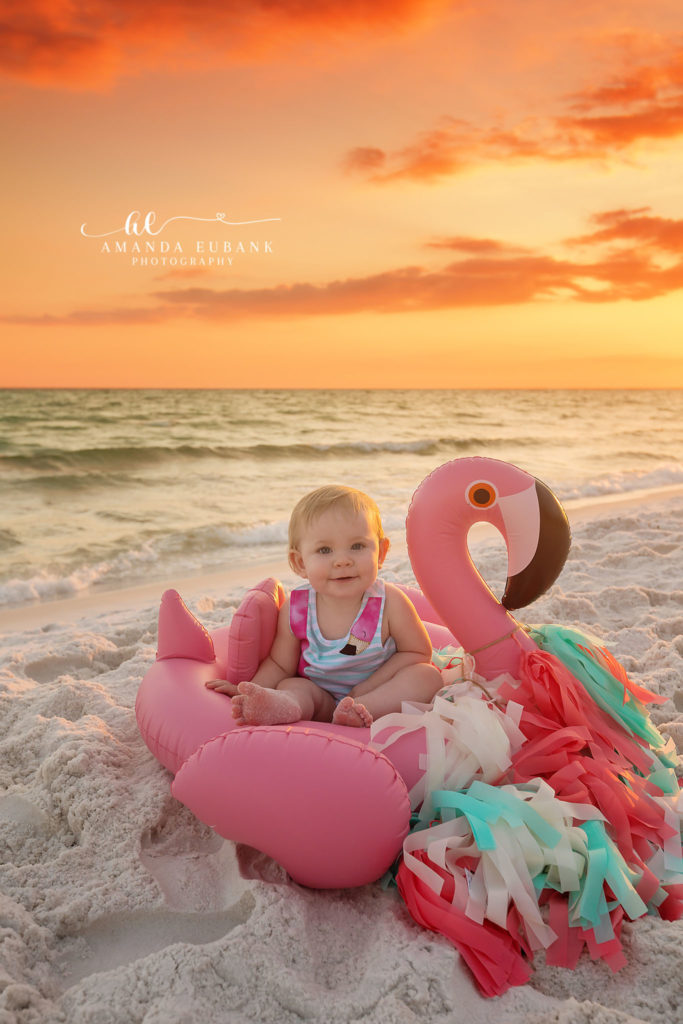 Miramar Beach photographer Amanda Eubank captures baby Sybi in a pink flamingo float at sunset on Florida's Emerald Coast