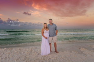Becky framed by the pastel hues of the Watercolor sunrise in a lavender gown