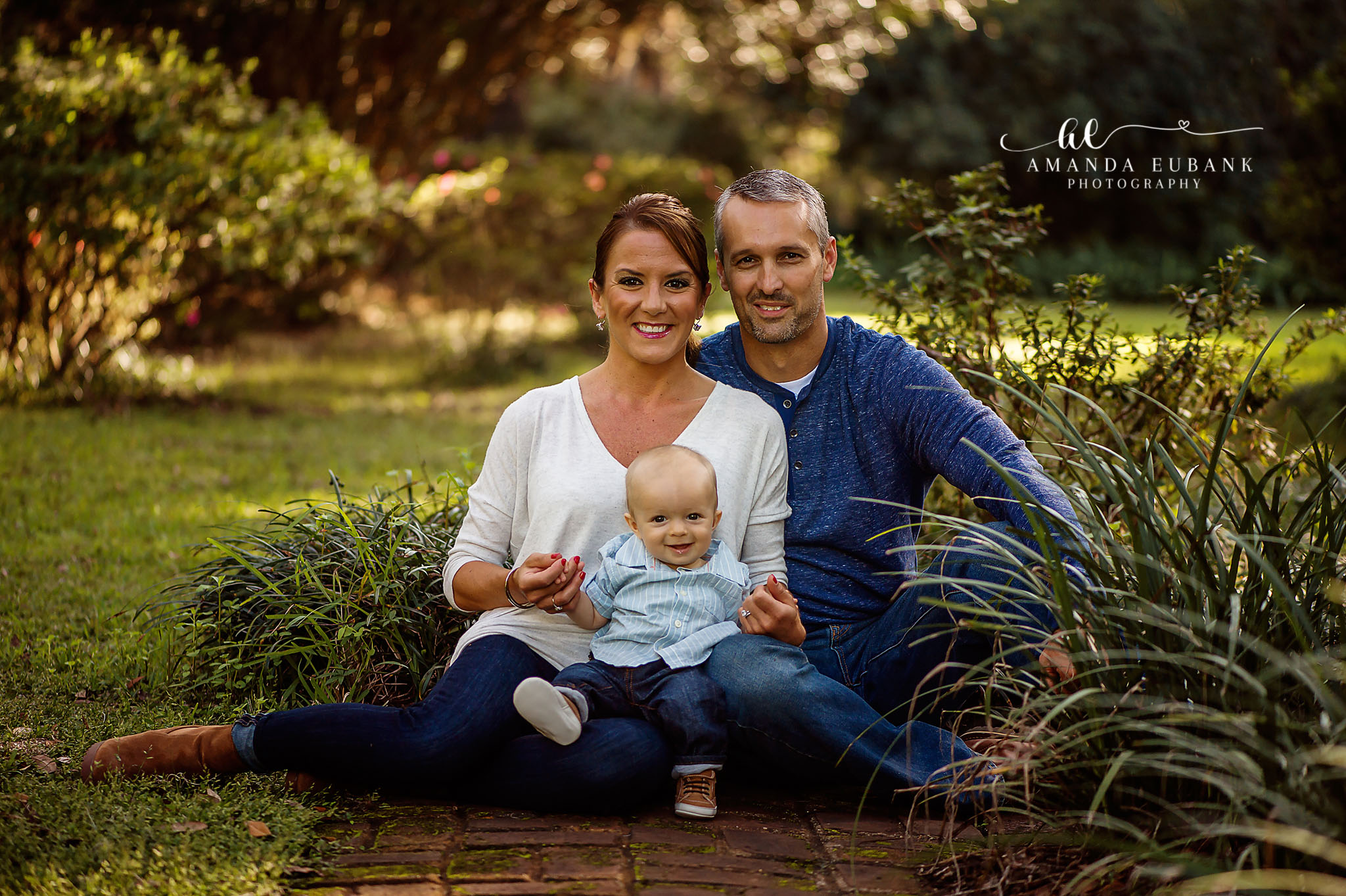 Eden Garden Photographer Taylor family portrait with parents and baby seated on the lawn at Eden Gardens