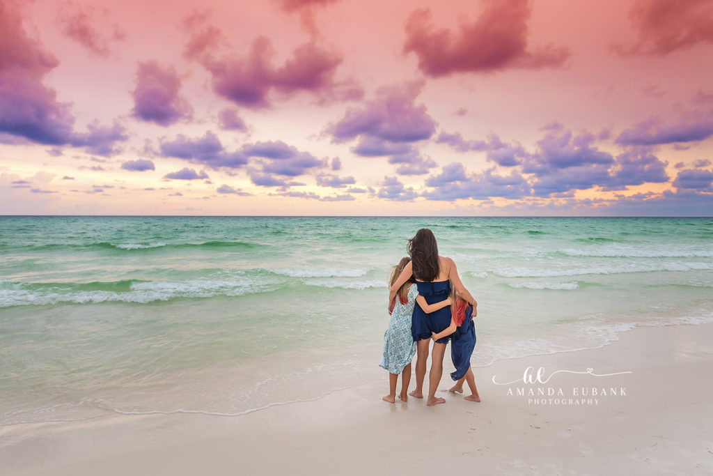 Mom swinging her youngest daughter through the air at twilight