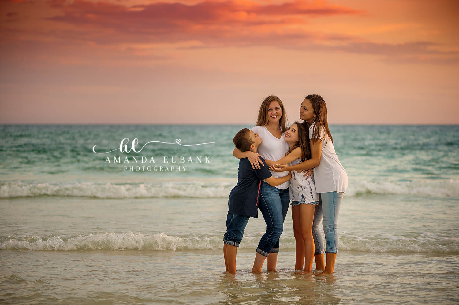 Blue Mountain Beach Florida Family Photographer | 30A Beach Family Photography Blue Mountain Beach Florida family photographer captures mom hugging three children in surf at sunset