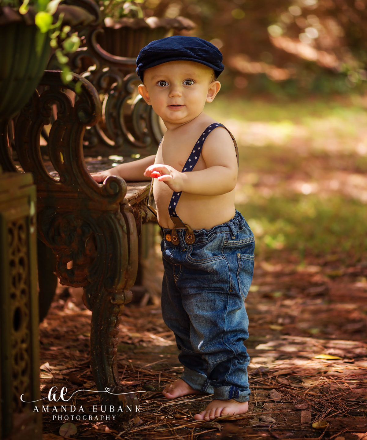 Family Photographers in Miramar Beach Florida | Family Photography Family photographers in Miramar Beach Florida capture toddler boy in newsboy cap and denim by ornate iron bench