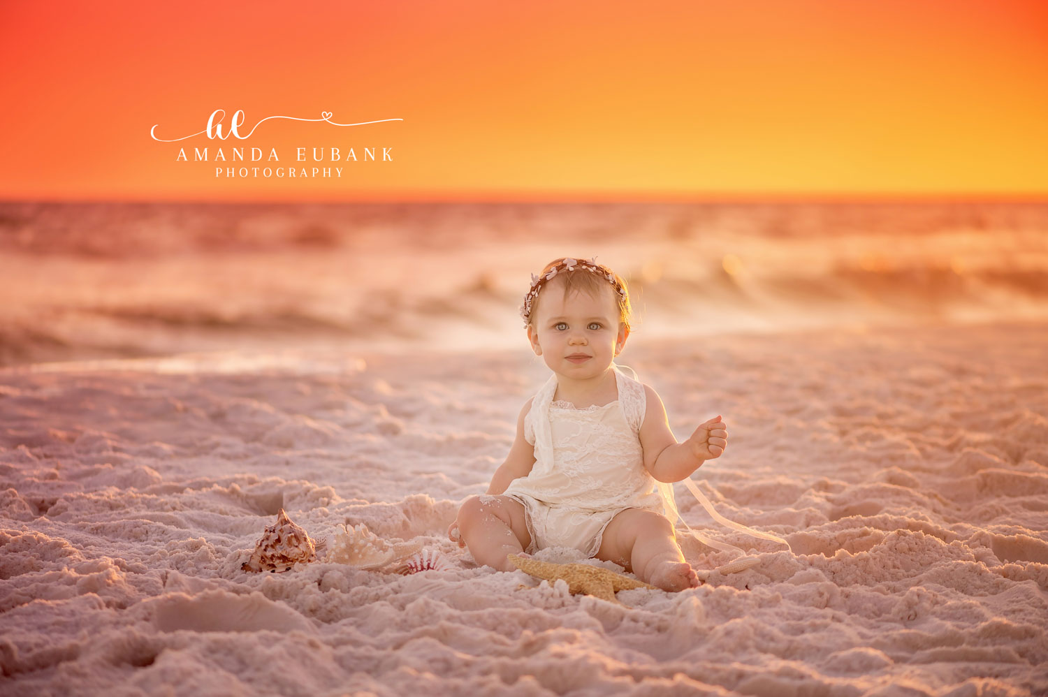 FAMILY PHOTOGRAPHERS IN SEAGROVE BEACH FLORIDA Family photographers in Seagrove Beach Florida capture toddler in white lace and floral crown on beach at sunset