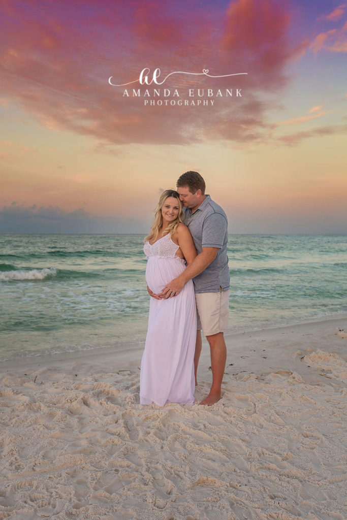 Sandestin Florida maternity photographer captures expecting couple in lavender on the beach at sunset