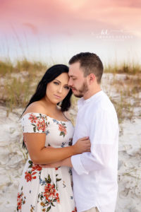 30A engagement photography after the storm: Shannon and Bryan embrace on the Santa Rosa Beach dunes at sunset.