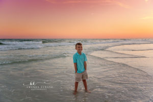 Mom hugging her kids on the Sandestin Beach sand at sunset