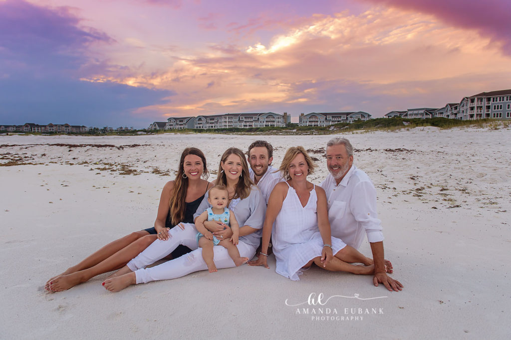 Family portrait at the water's edge with the emerald Gulf behind them
