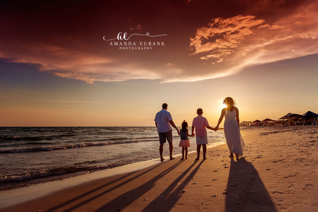 Hallock family piggyback moment caught at golden hour on the beach