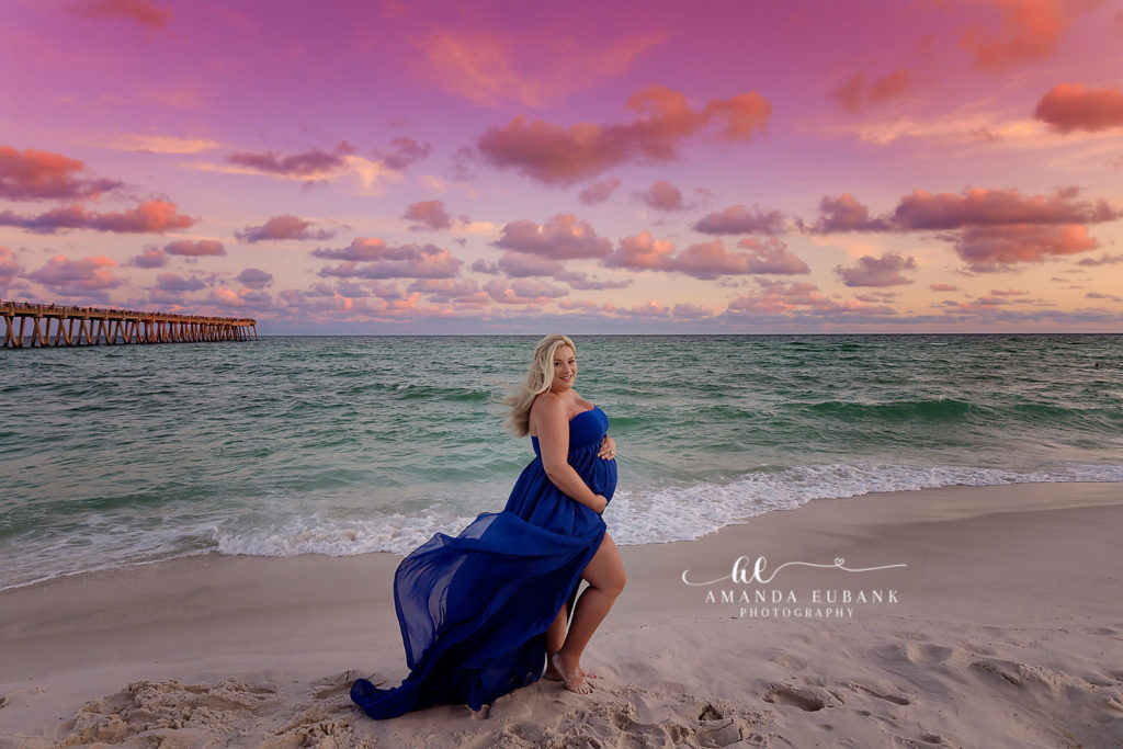 Danielle walking the Santa Rosa shoreline with her bump in the warm coastal light