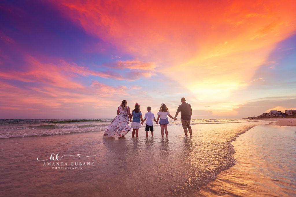 Dad walking the shoreline with his kids during the Jones family session