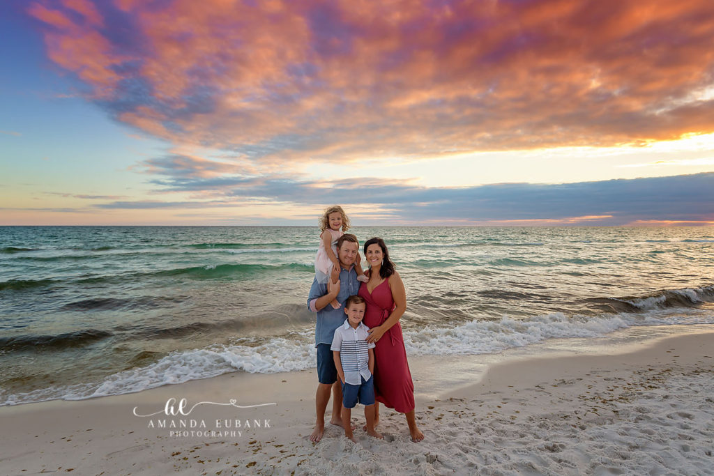 Loving final portrait of the Garland family glowing in the majestic Emerald Coast sunset