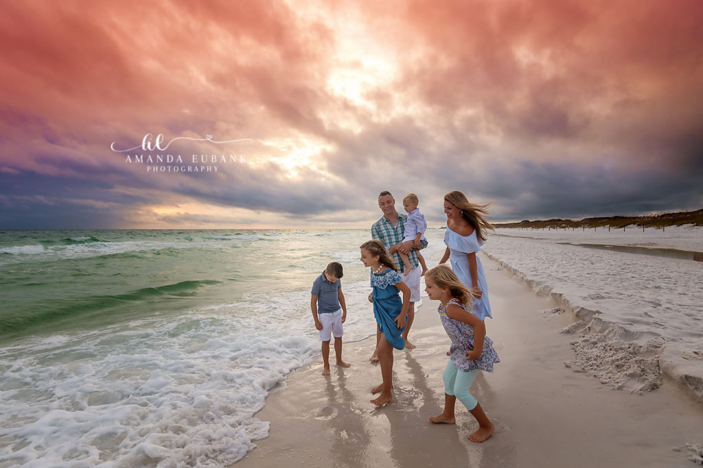 Final beach portrait of the Davis family beneath some of the best clouds of the year