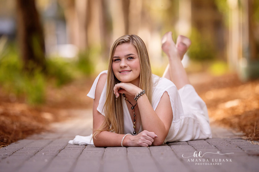 Ivy-side bloom frames Ansley during her Watercolor senior portrait session
