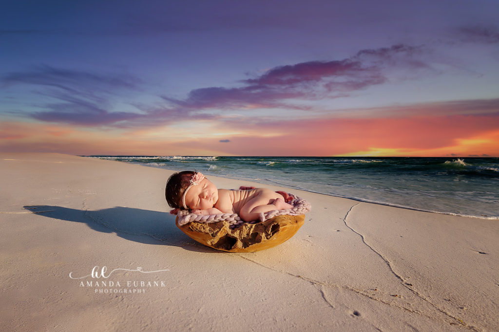 Sweet baby Everly cradled in her momma's arms during her Miramar Beach newborn session at sunset