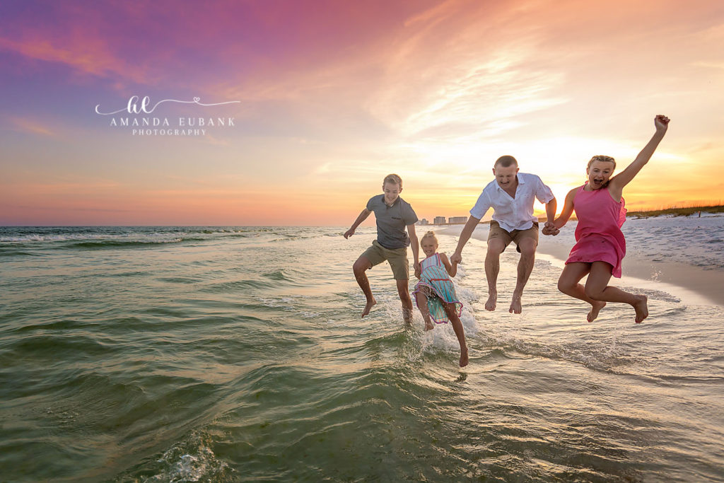 Joyful candid of the siblings running together beneath beach-glow magic