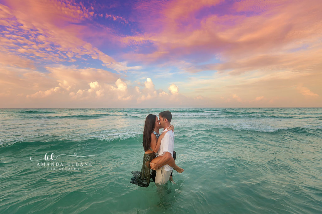 romantic couple celebrating their anniversary at Sandestin sunset beach with ocean-mist twilight, dreamy environmental landscape
