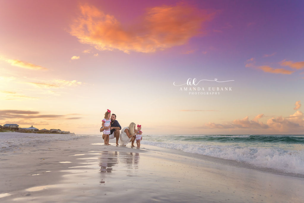 Little girls splashing in the morning seafoam during the Winters sunrise session