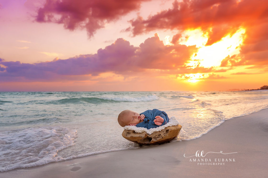 Destin newborn photographer captures Baby E curled in a wooden bowl in soft blue knit