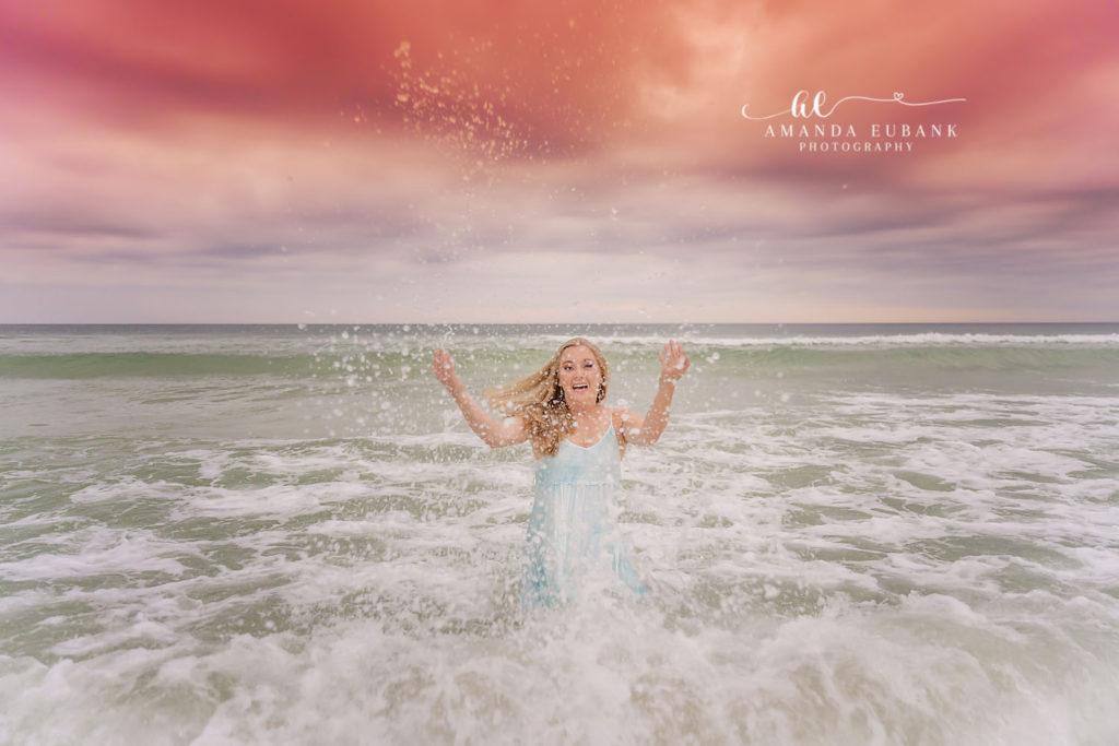 Watercolor senior session ends with Isabella's playful dip in the gulf in her flowing dress