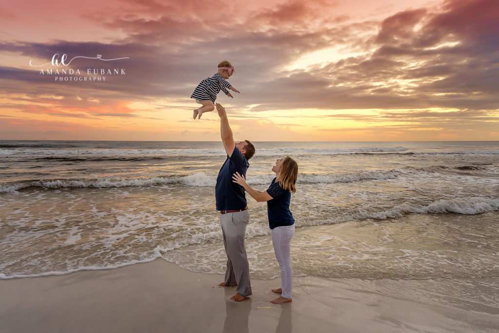 Slattery family laughs together at sunset under a stunning sky on Florida's 30A coast