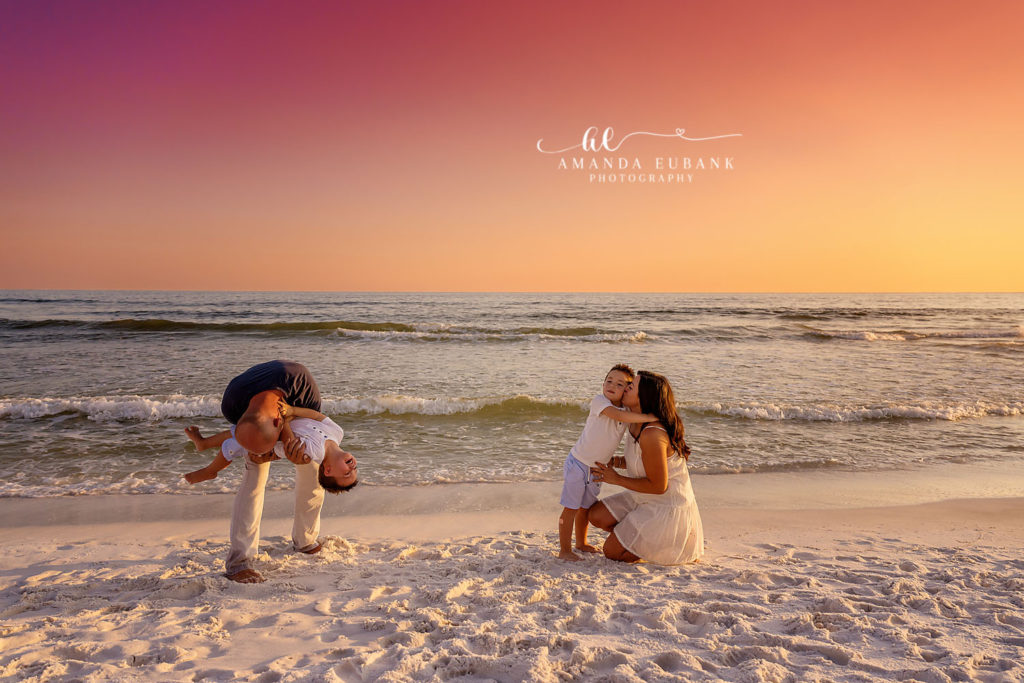Mom, dad, and their two boys pose for a classic family portrait on the 30A beach at sunset