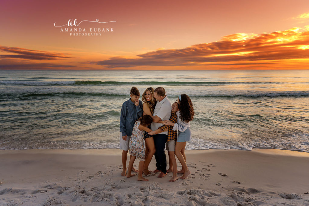 Sunset family portrait of the Atkinsons in blue and white on Rosemary Beach.