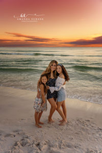 Atkinson family pausing at the water's edge at Rosemary Beach during their sunset session.