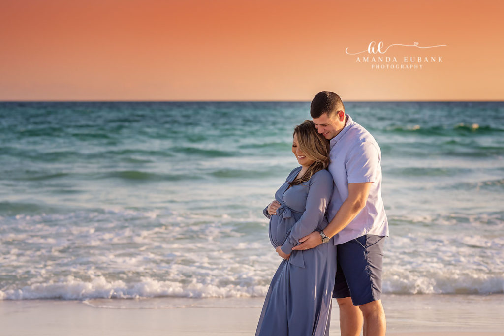Katrina's light-blue maternity gown flowing in the breeze along the WaterColor Beach shoreline.