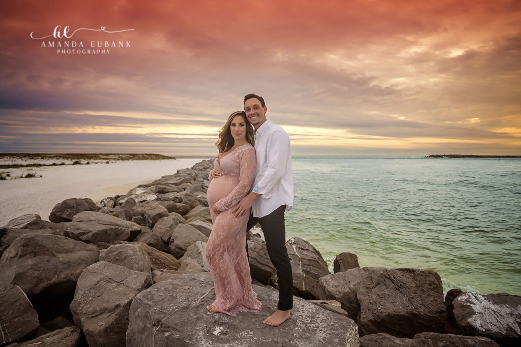 Austin and Libby sharing a quiet sunset moment on the sand at the Destin Jetties.
