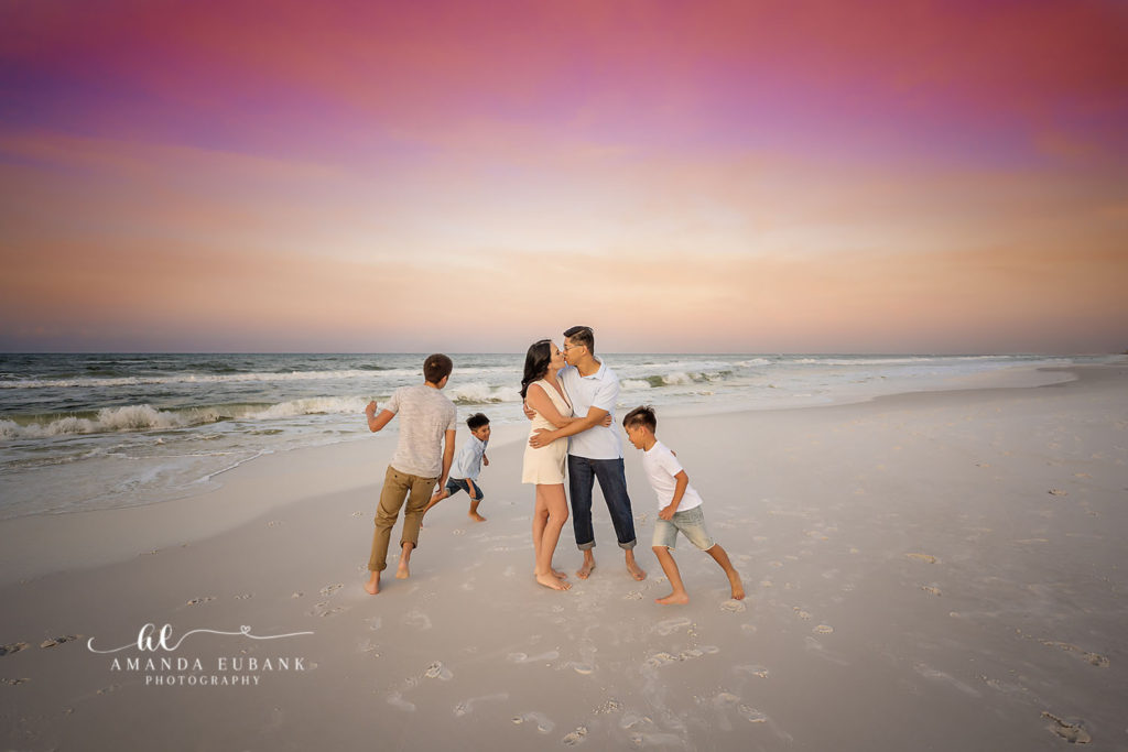 Full Chang family group hug at Destin Beach during their sunrise photography session.