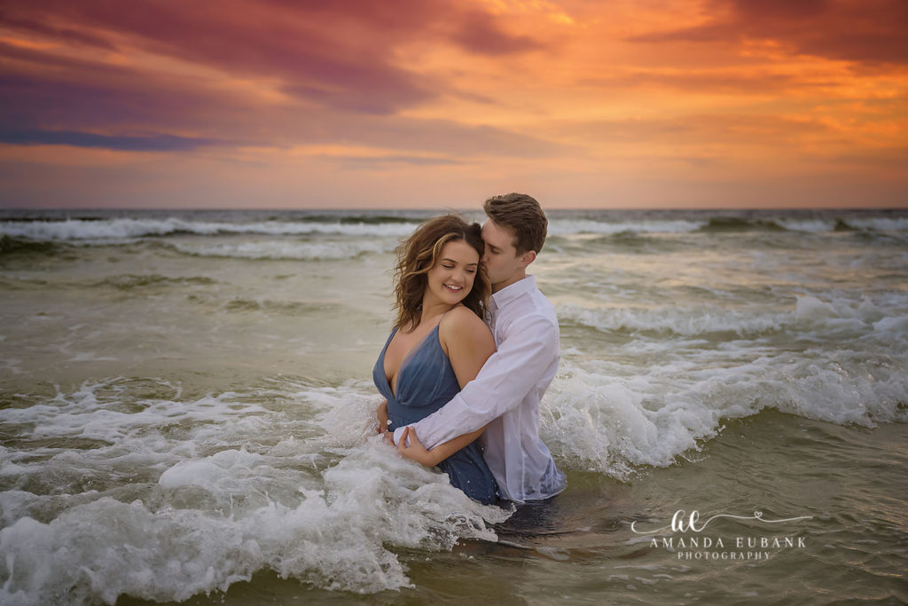 Ally and Curtis sharing a final golden hour kiss on the sand at Watercolor Beach.