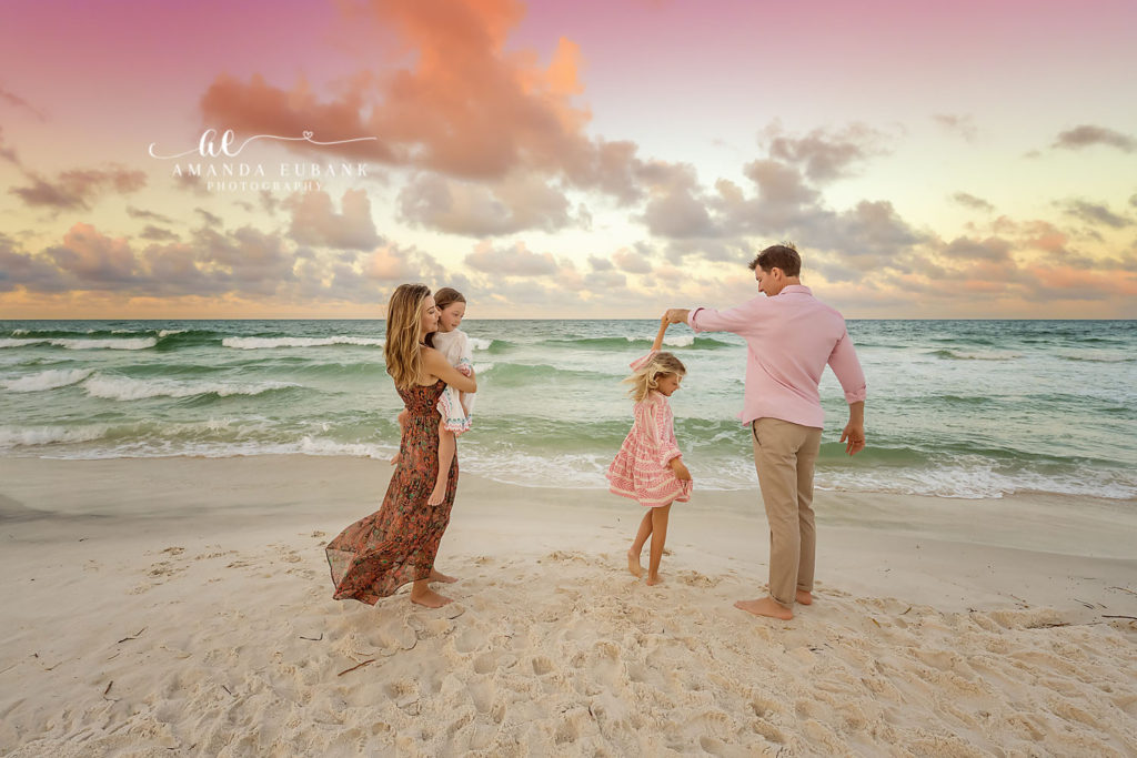 The youngest P daughter being held by her dad with the Gulf horizon behind them.
