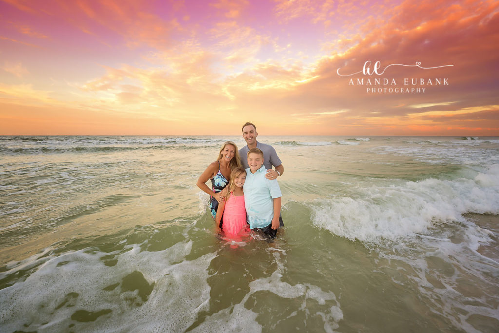 G Family captured walking toward the Gulf in coordinated outfits at first light on 30A.