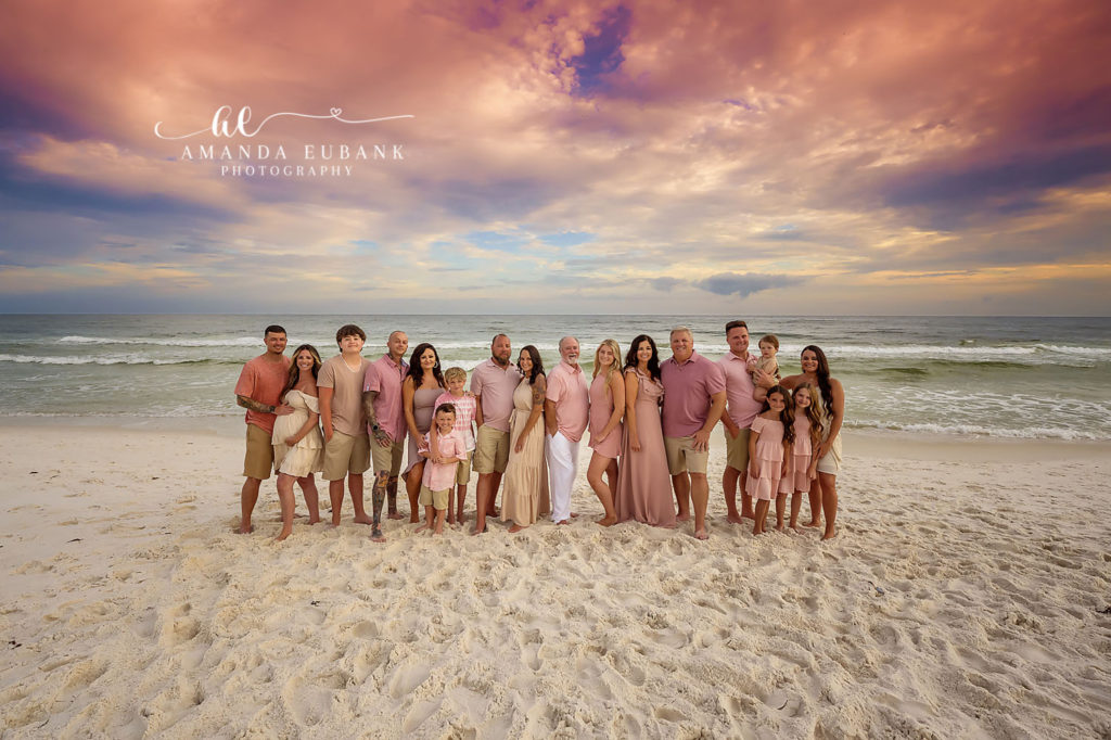 P family extended family portrait in coordinated pink tones on Carillon Beach at sunset.