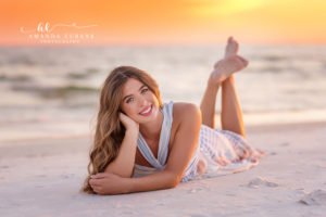 Hannah at the Gulf shoreline in a pastel striped maxi dress during her Rosemary Beach senior session.