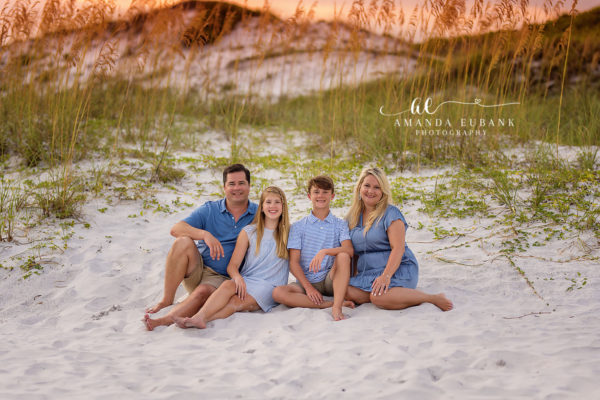 Boho Watersound Family Beach Portrait — Frame 226 Mom, dad and kids smiling barefoot in the sand at sunset on Watersound Beach in coordinated coastal blues.