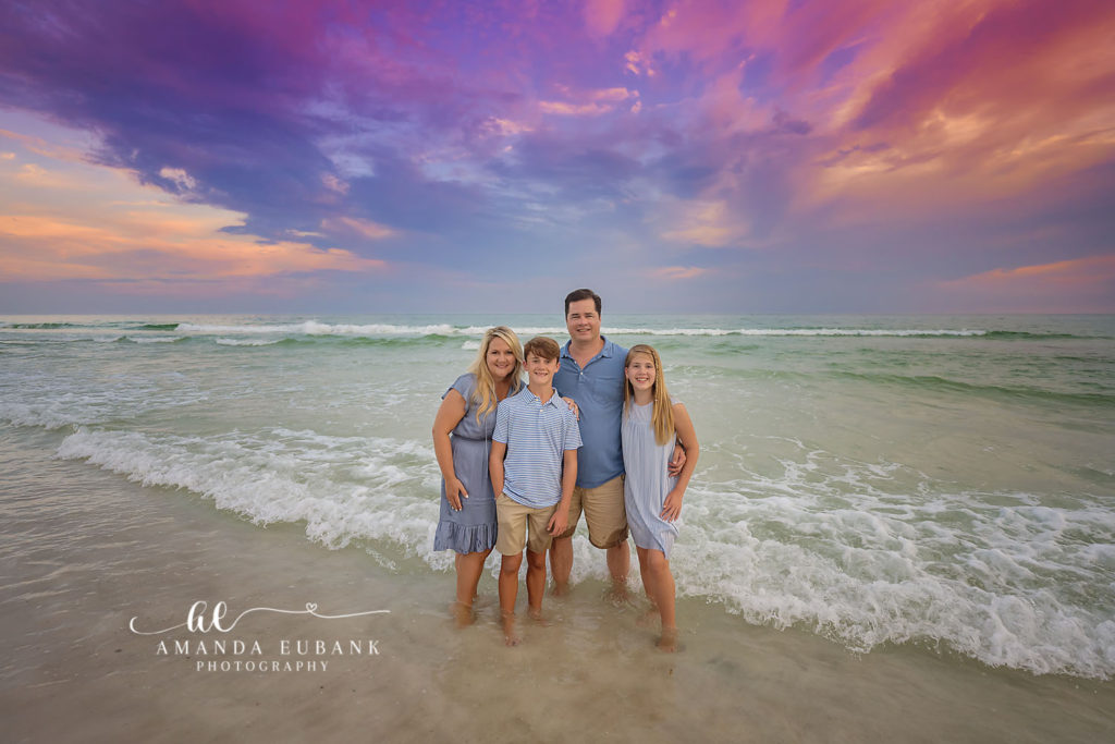 T family laughing together during a candid moment at their Watersound Beach photography session.