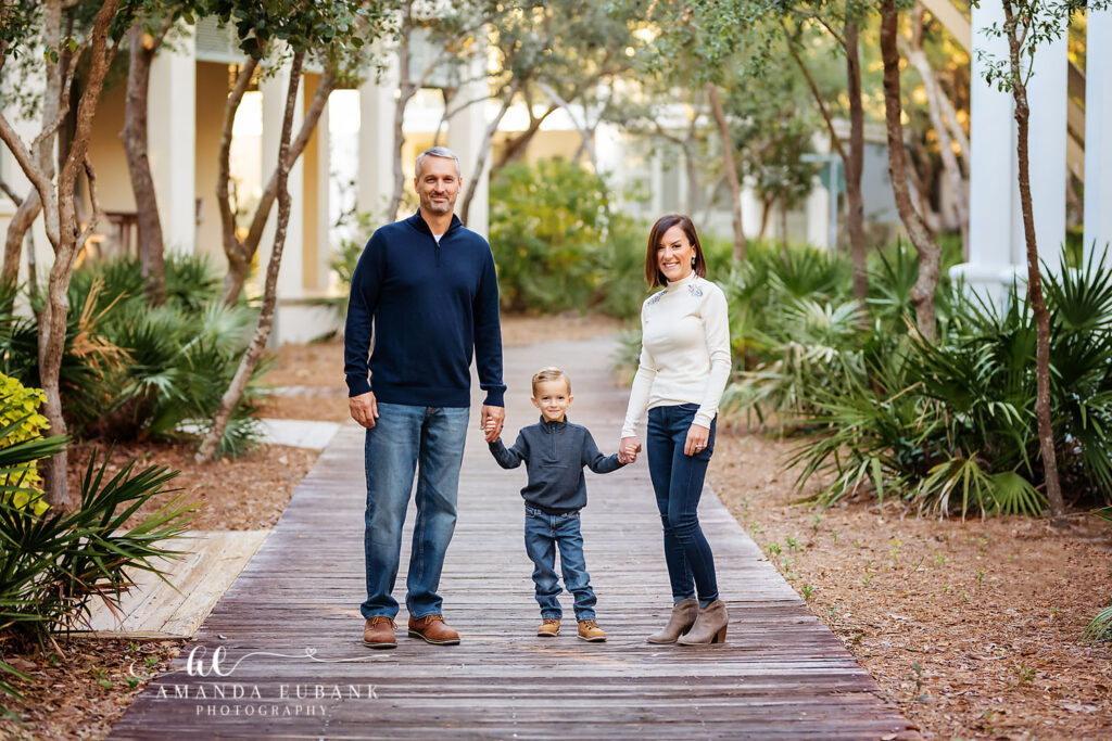 Taylor family gathered on the lush boardwalk path during their Rosemary Beach session