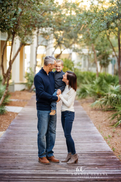 Rosemary Beach Family Portrait 003 Taylor parents holding hands with their toddler on the Rosemary Beach walkway