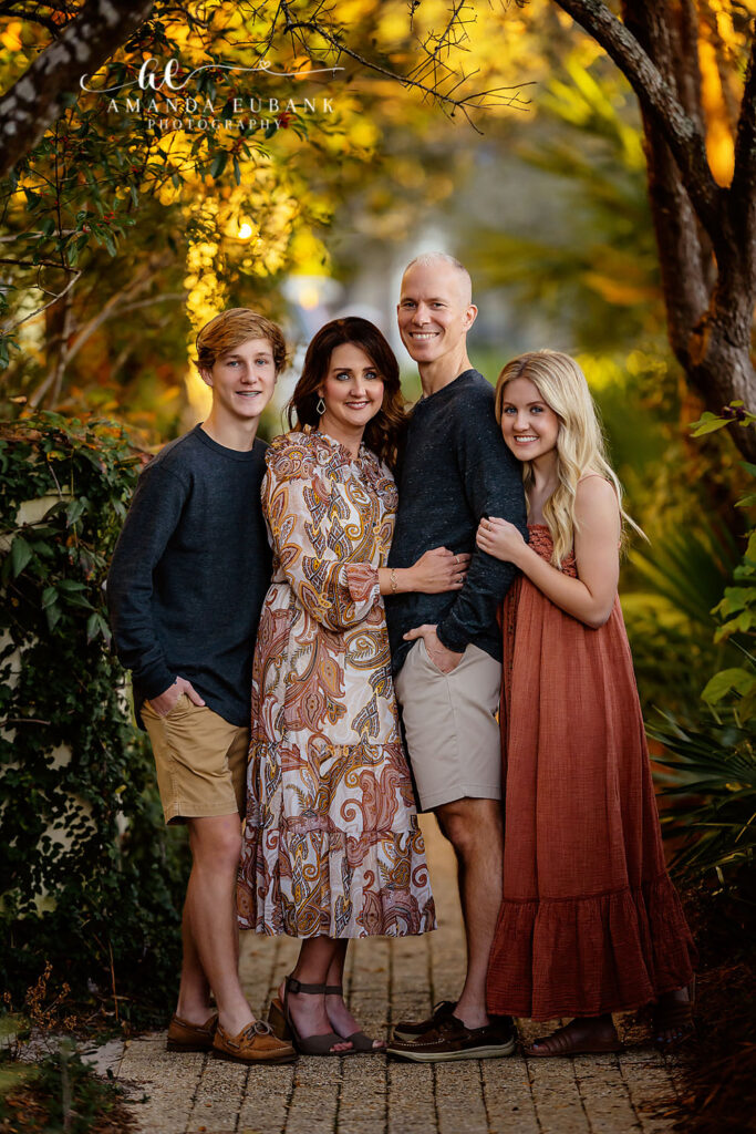 S Family exchanging gentle smiles outside a Rosemary Beach storefront on a crisp 30A afternoon.