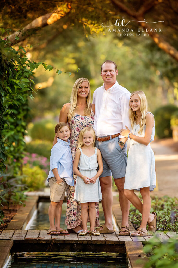 Madden family of five gathered on the Watercolor garden footbridge over the reflecting pool