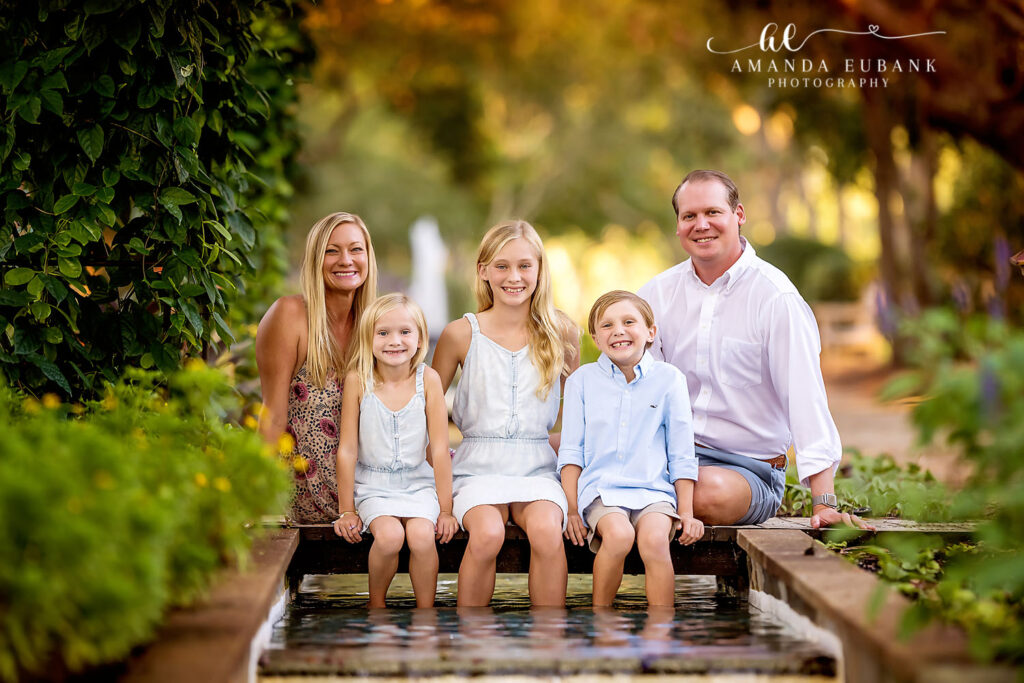 Candid Madden family laugh along the Watercolor garden path during sunset session