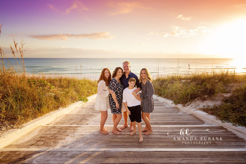 Clark parents with their three children and pups posed on the Seaside cottage steps