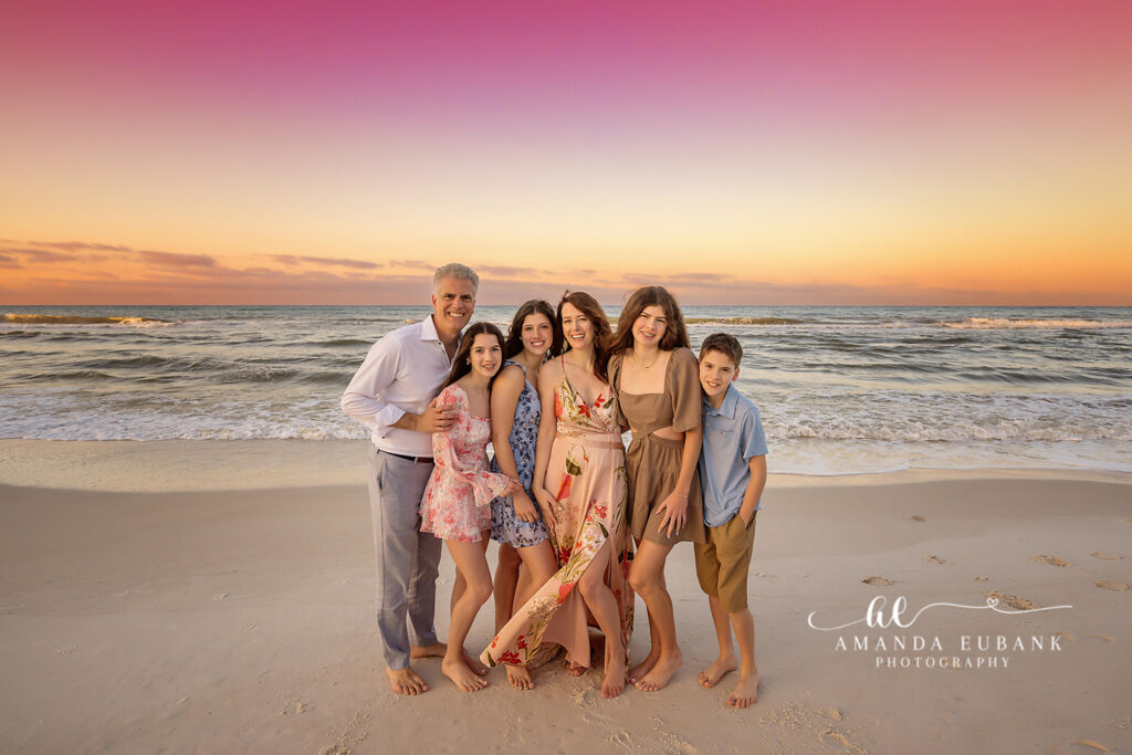 Creswell teen in a lavender floral dress, over-the-shoulder glance during her Rosemary Beach sunrise senior portrait.